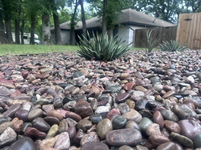 Finished river rock bed with steel edging