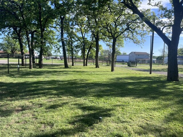 Healthy, well-maintained lawn with mature trees
