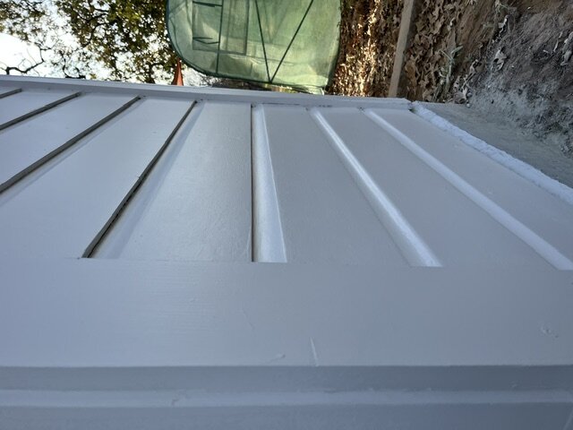 Freshly painted white lap siding, close-up detail
