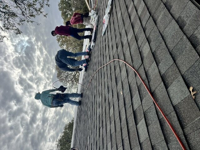 Viva Green roofing crew installing shingles on a residential roof