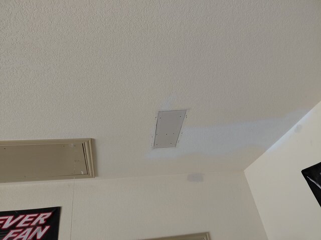 Drywall patch repair with mesh tape, ready for mudding